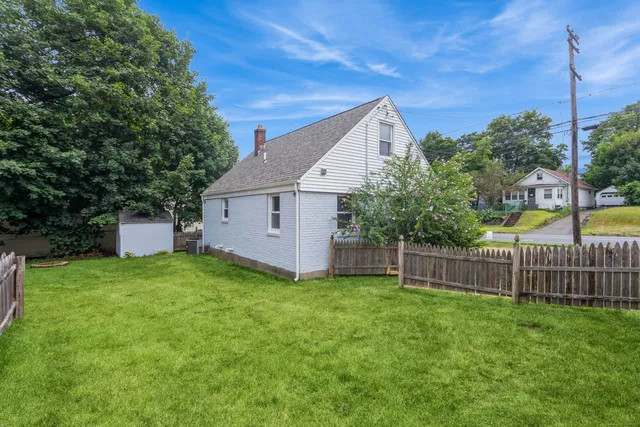 a view of a house with backyard and sitting area