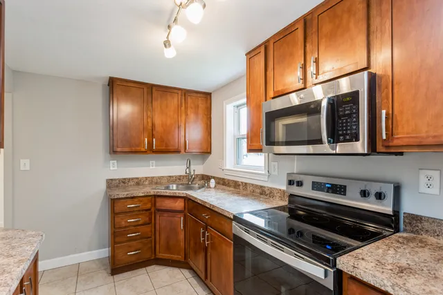 a kitchen with a sink and a stove top oven