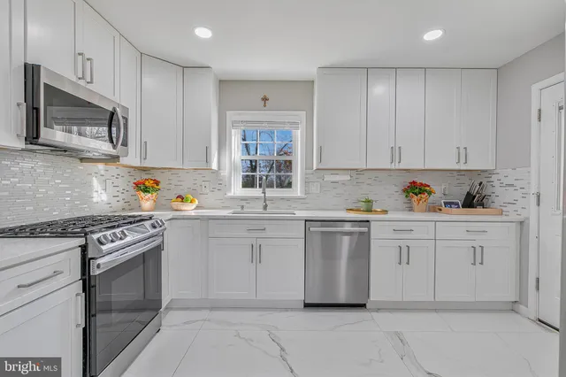 a bedroom with two beds and a chandelier