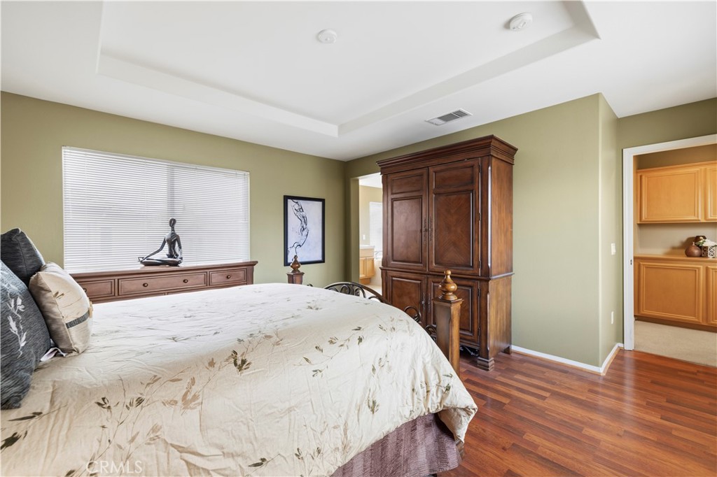 28940 Mirada Circulo Valencia, CA 91354 - Photo 15 of 25 a bedroom with a bed and wooden floor