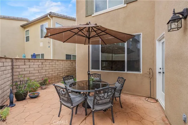 a patio with a patio table and chairs