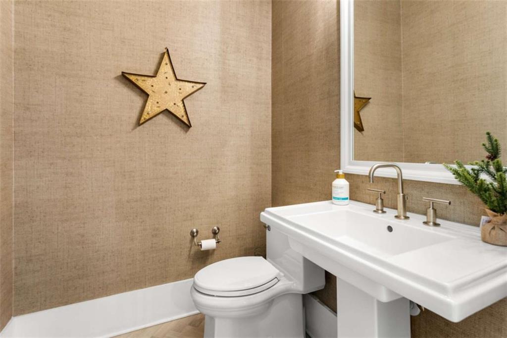 1585 Dabbs Bridge Road Dallas, GA 30132 - Photo 15 of 32 a bathroom with a sink a toilet and a mirror