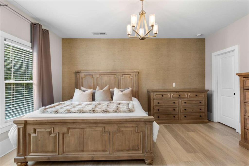 1585 Dabbs Bridge Road Dallas, GA 30132 - Photo 17 of 32 a bedroom with a bed and a chandelier