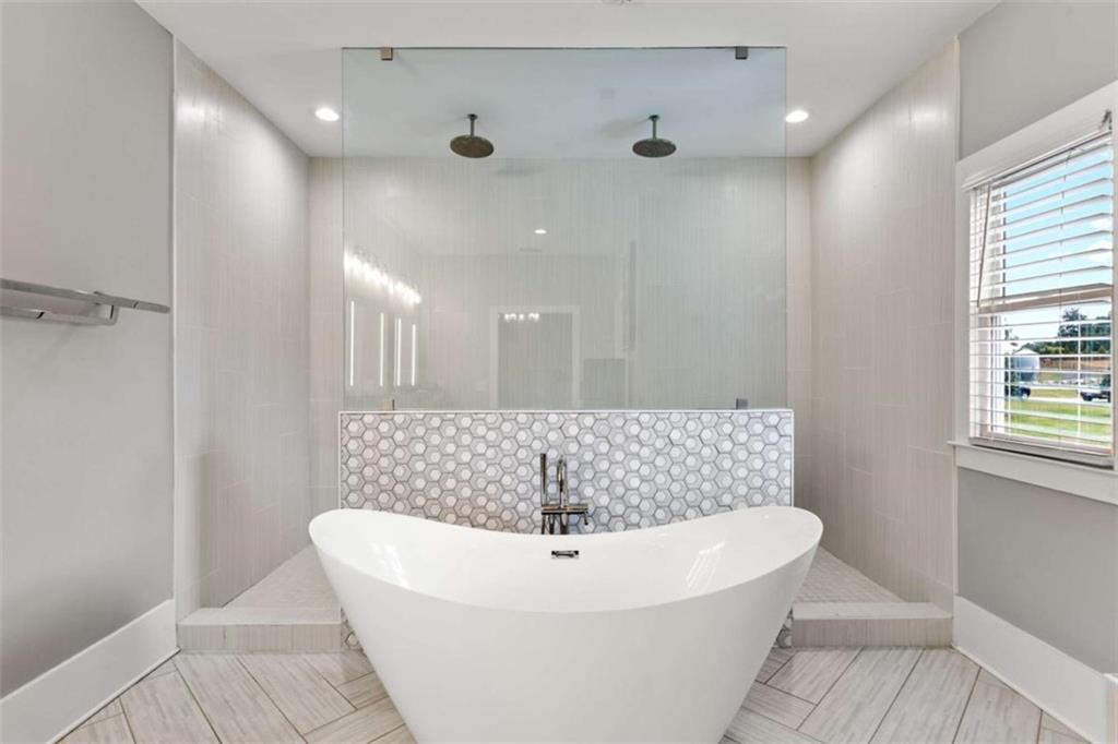 1585 Dabbs Bridge Road Dallas, GA 30132 - Photo 20 of 32 a bathroom with a sink a bathtub and shower