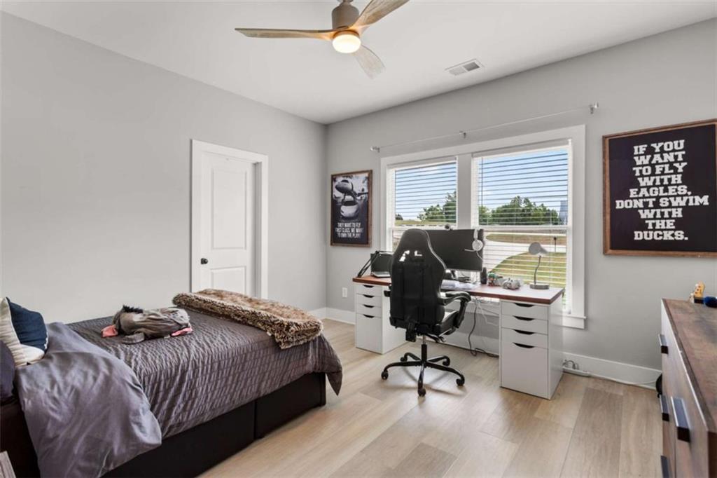 1585 Dabbs Bridge Road Dallas, GA 30132 - Photo 23 of 32 a bedroom with a bed and a desk