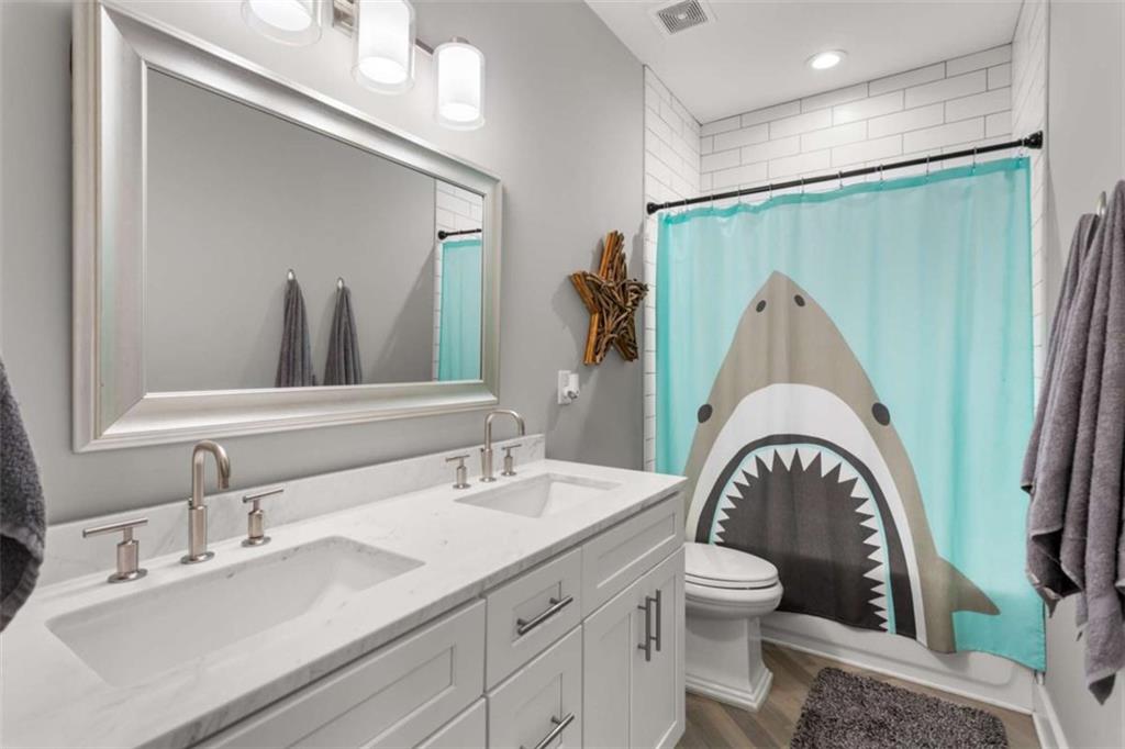 1585 Dabbs Bridge Road Dallas, GA 30132 - Photo 24 of 32 a bathroom with a sink a toilet and a mirror