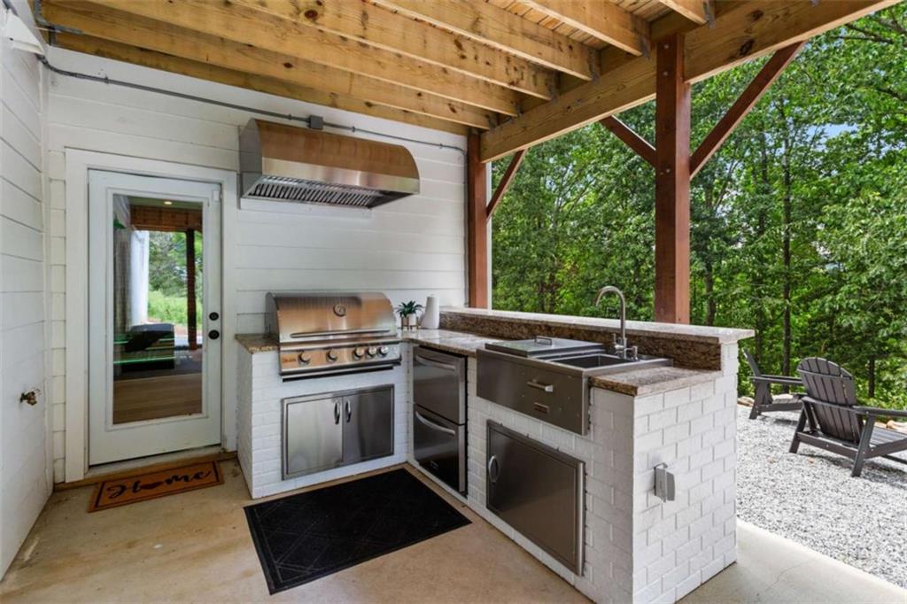 1585 Dabbs Bridge Road Dallas, GA 30132 - Photo 31 of 32 a view of a kitchen with a stove top oven and a garden