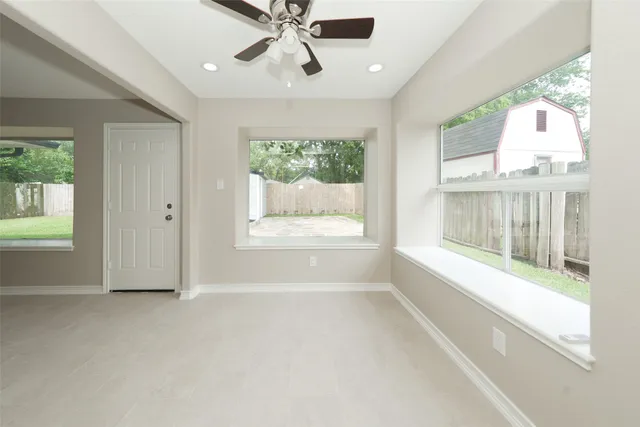 an empty room with windows and outdoor view