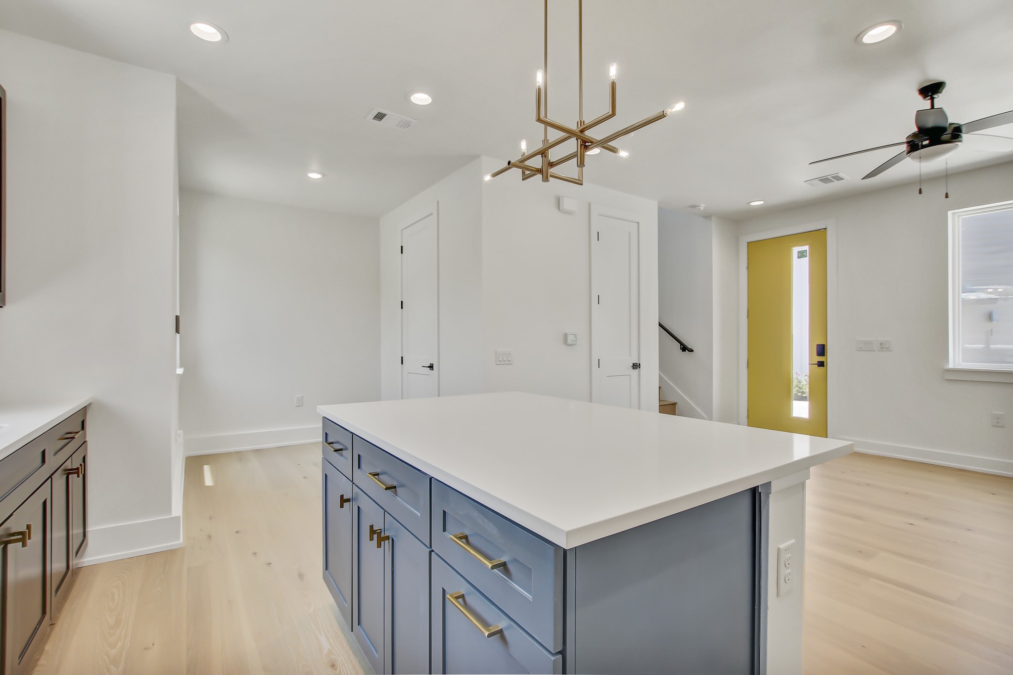 4127 East 12th Street, Unit 8 Austin, TX 78721 - Photo 12 of 32 Kitchen with light wood-style floors, recessed lighting, baseboards, a center island, and a ceiling fan