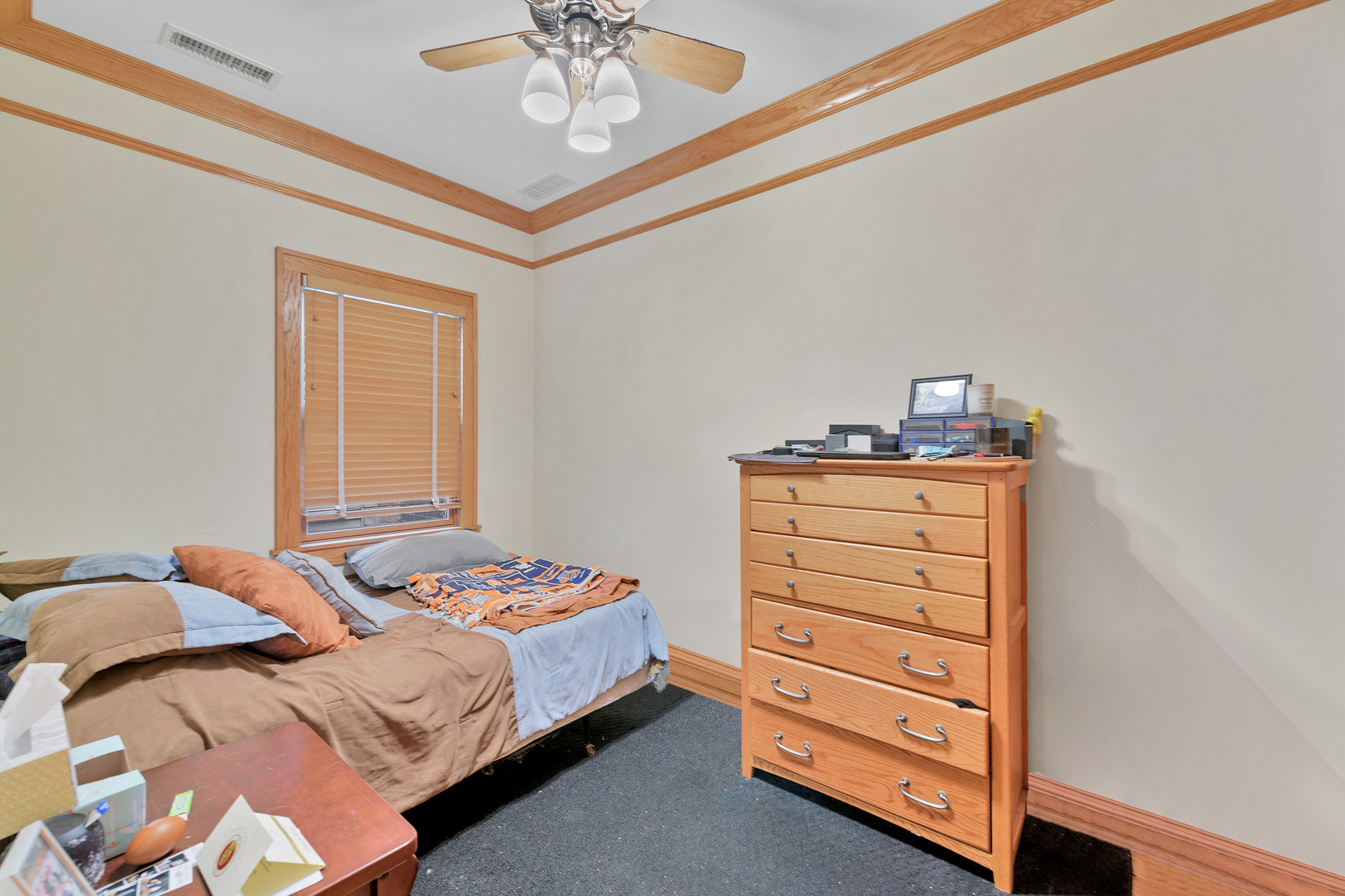 Undisclosed Address Chicago, IL 60657 - Photo 13 of 18 a bedroom with a bed and a chandelier