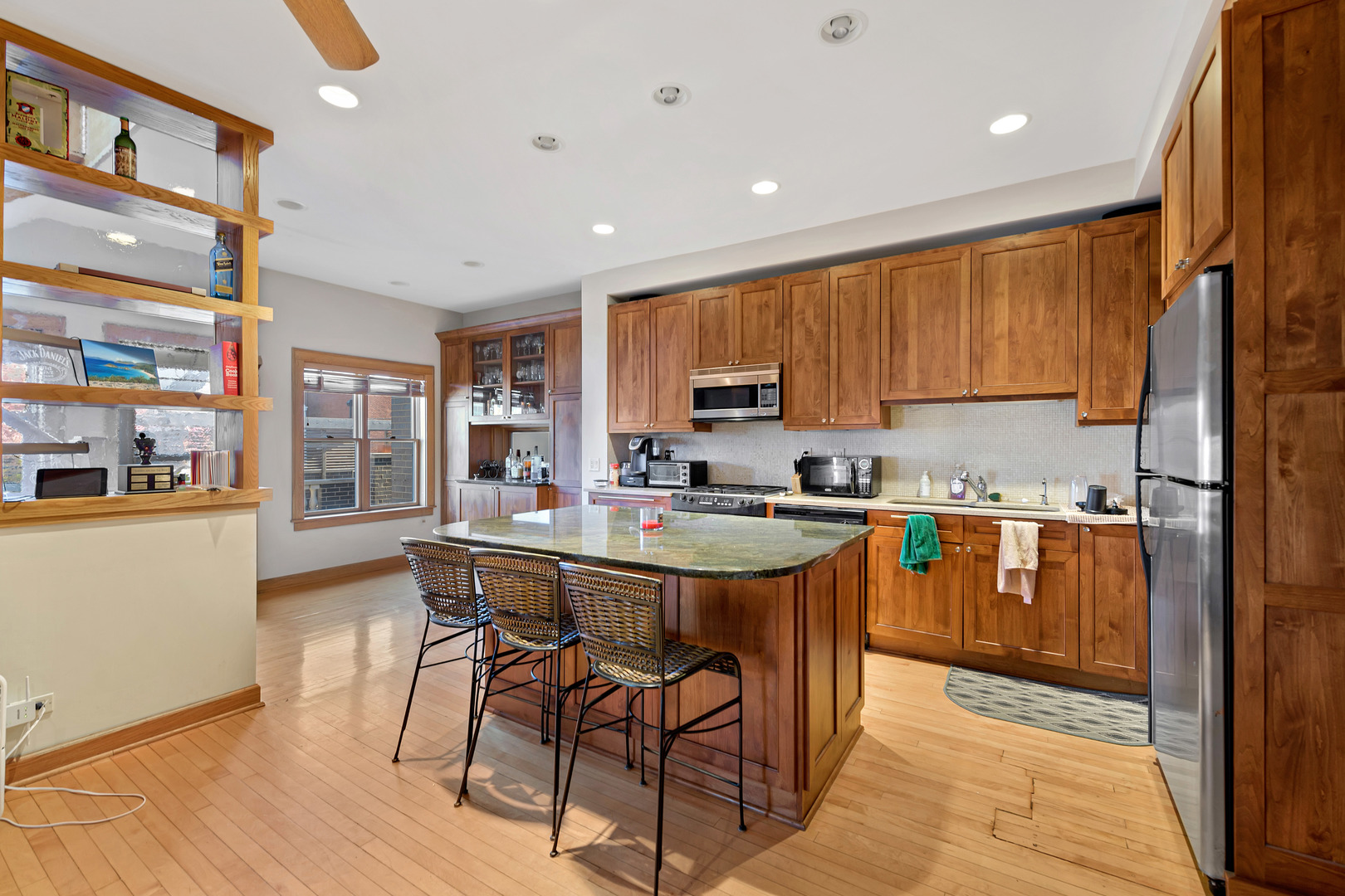 Undisclosed Address Chicago, IL 60657 - Photo 5 of 18 a kitchen with stainless steel appliances a stove a sink a refrigerator and cabinets