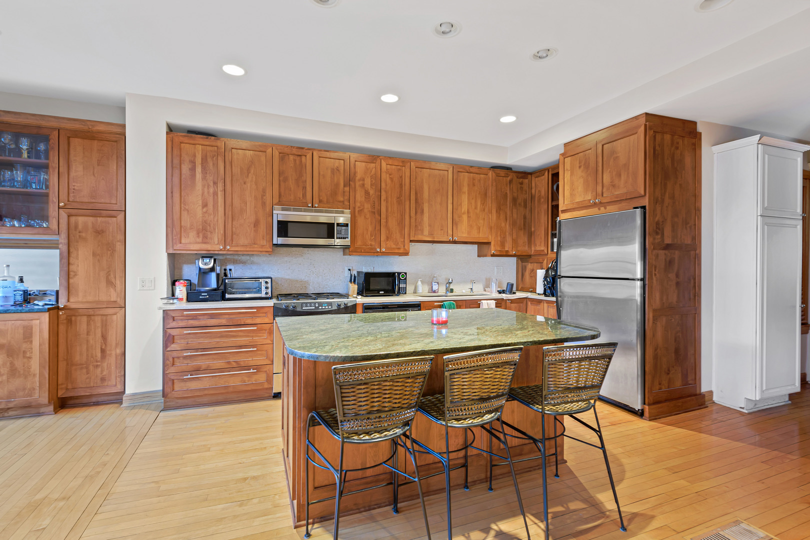 Undisclosed Address Chicago, IL 60657 - Photo 6 of 18 a kitchen with a refrigerator a stove top oven a sink and cabinets
