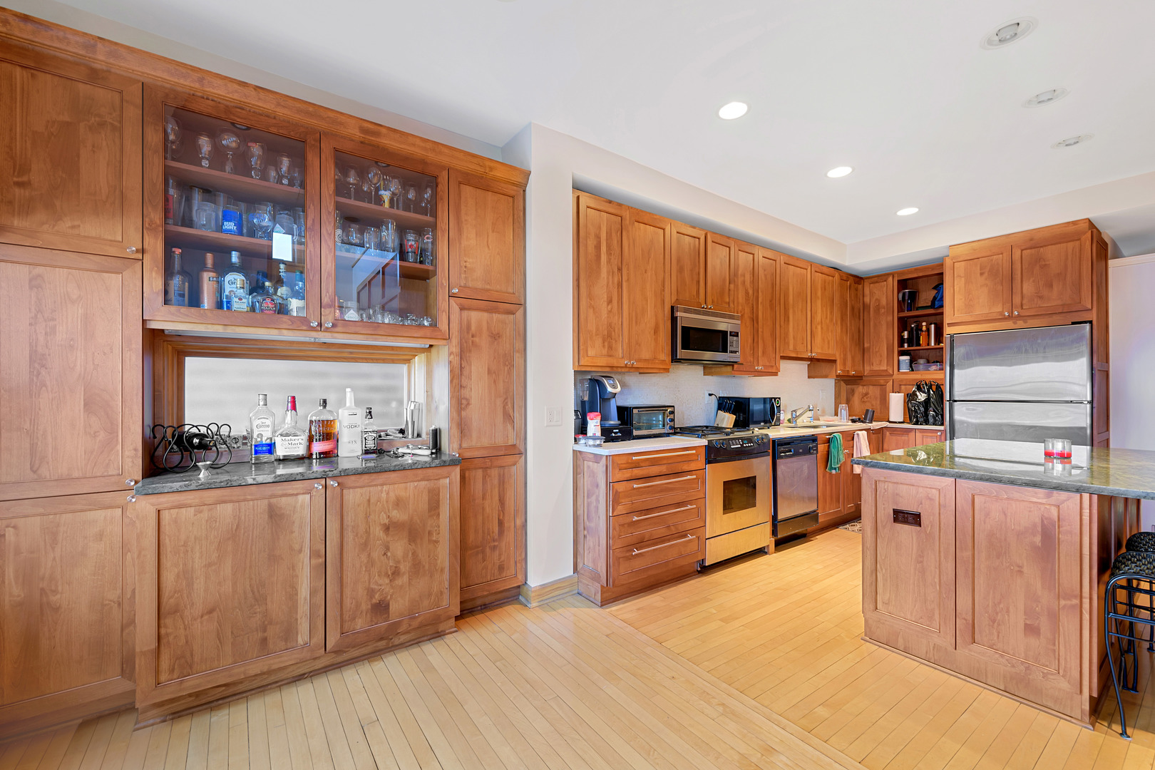 Undisclosed Address Chicago, IL 60657 - Photo 7 of 18 a kitchen with stainless steel appliances granite countertop a stove top oven a sink dishwasher a refrigerator and cabinets with wooden floor