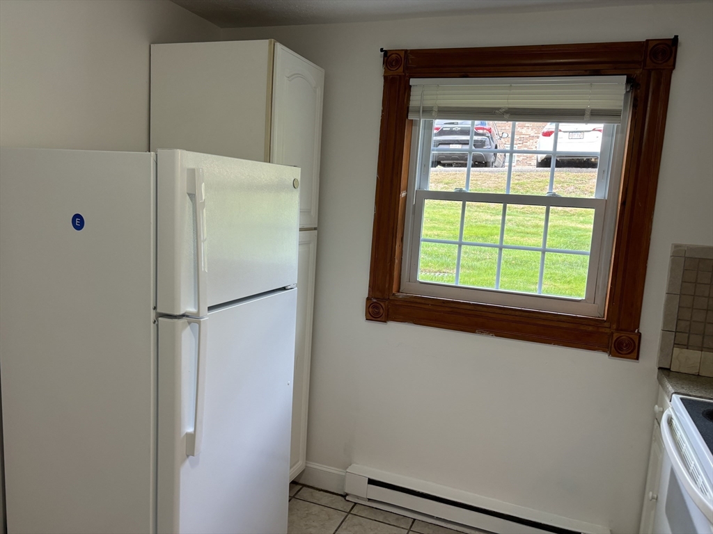 1 Walker Road, Unit 3 North Andover, MA 01845 - Photo 9 of 13 a white refrigerator freezer sitting inside of a kitchen