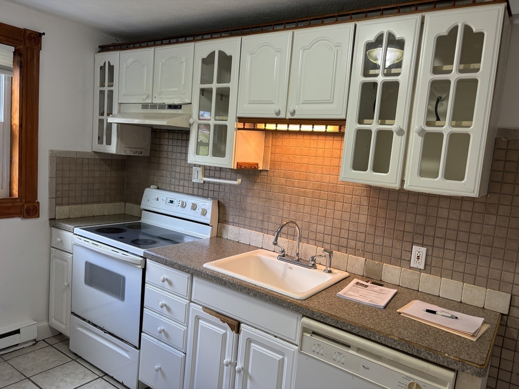 1 Walker Road, Unit 3 North Andover, MA 01845 - Photo 10 of 13 a kitchen with stainless steel appliances granite countertop a sink stove and cabinets