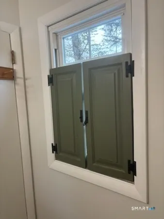 a bathroom with a window and a shower