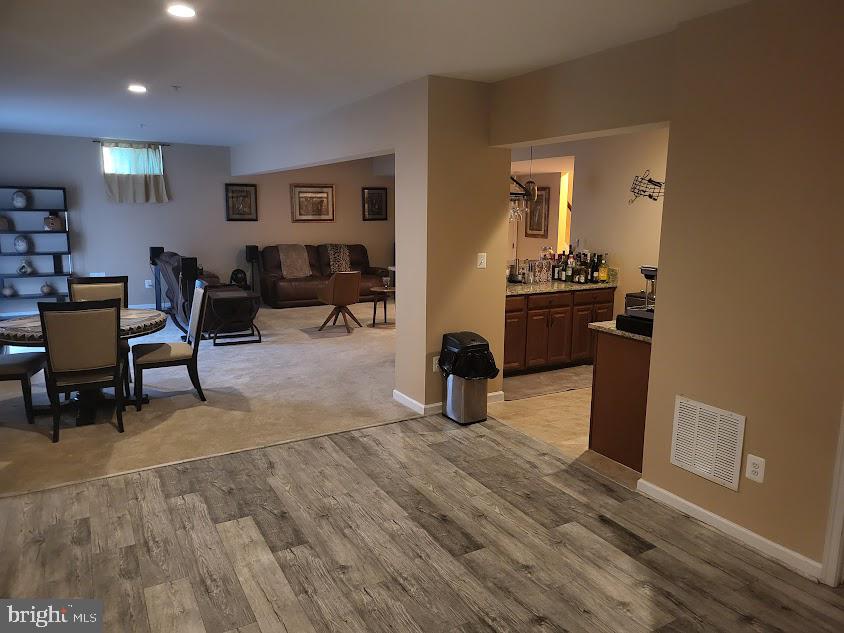11013 Jumping Way Upper Marlboro, MD 20772 - Photo 21 of 51 a living room with furniture a dining table and chairs with wooden floor