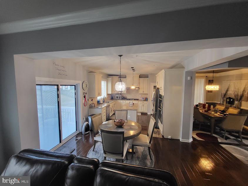 11013 Jumping Way Upper Marlboro, MD 20772 - Photo 40 of 51 a view of a dining room with furniture and wooden floor
