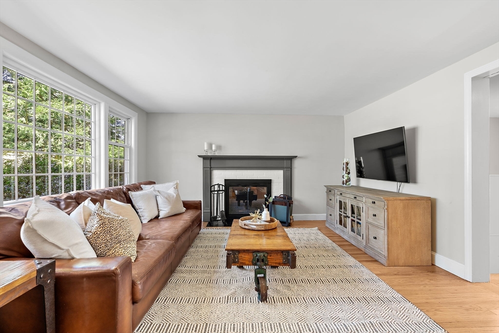 13 Mohegan Road Acton, MA 01720 - Photo 15 of 39 a living room with furniture a flat screen tv and a fireplace