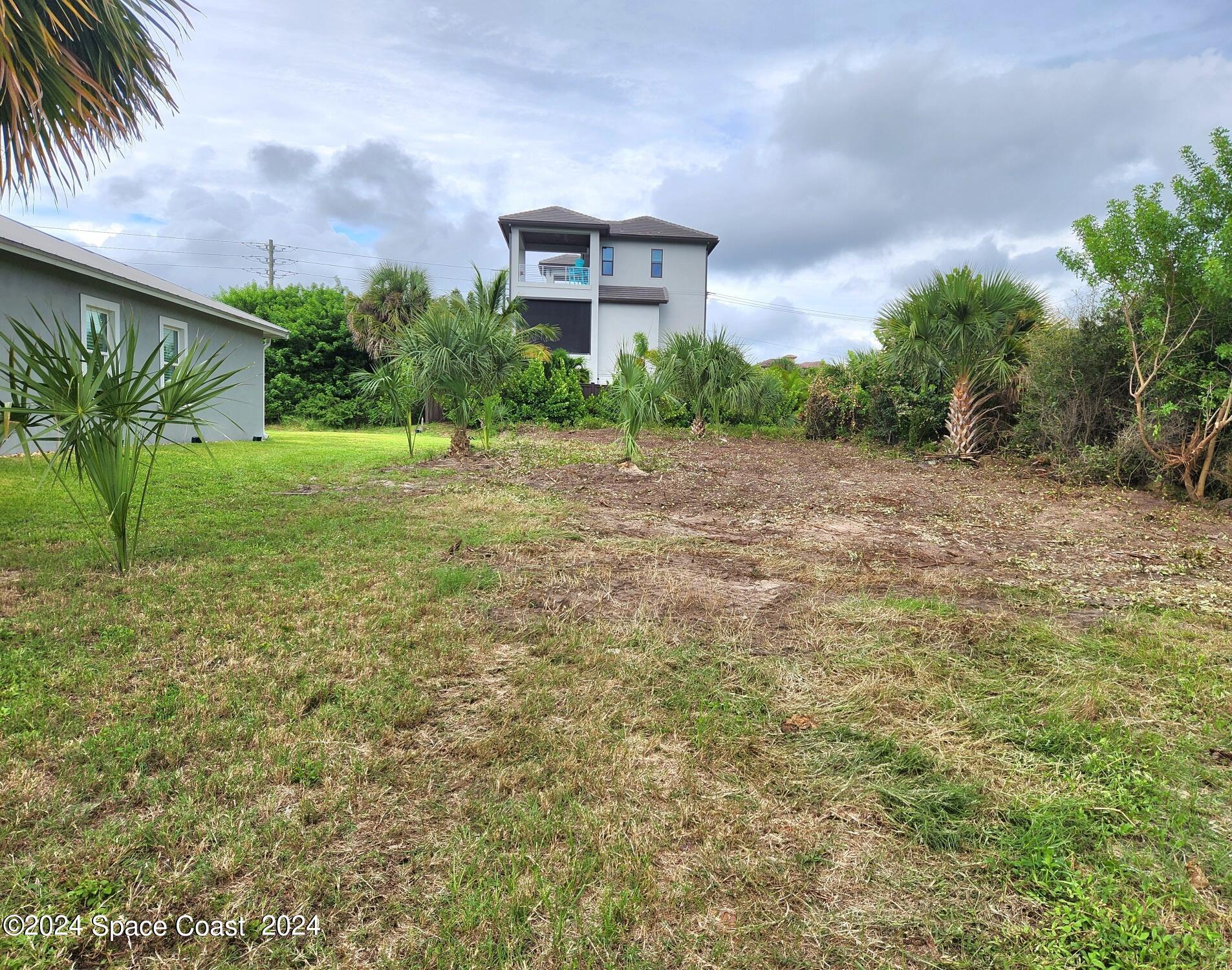 7308 Stuart Avenue Melbourne Beach, FL 32951 - Photo 12 of 16 a view of a yard in front of a house