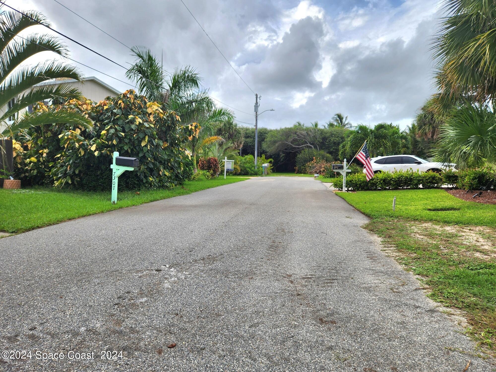 7308 Stuart Avenue Melbourne Beach, FL 32951 - Photo 14 of 16 a view of a park with plants and a trees