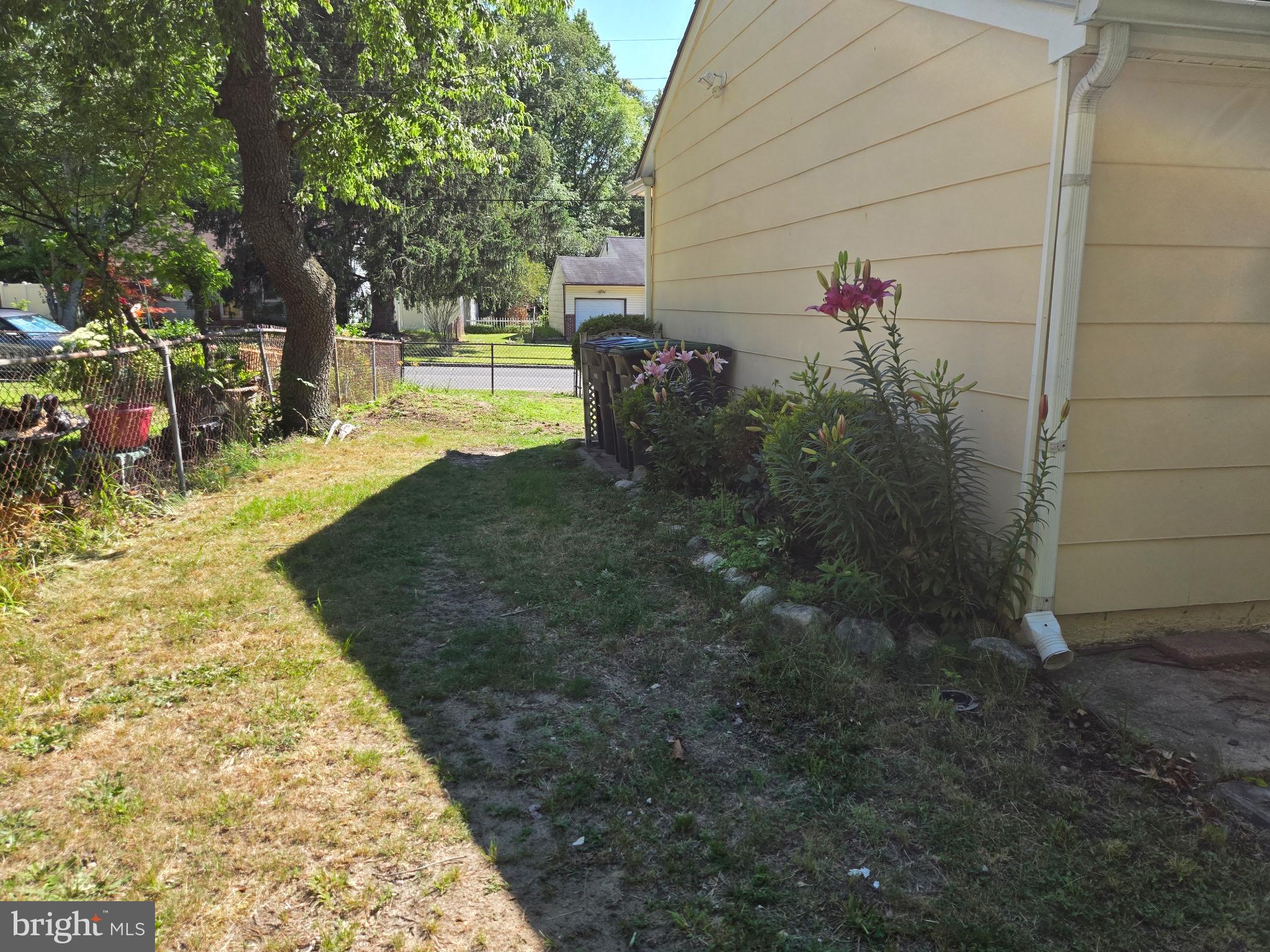 909 Bentley Road Lindenwold, NJ 08021 - Photo 5 of 15 Lush garden path beside a cozy home.