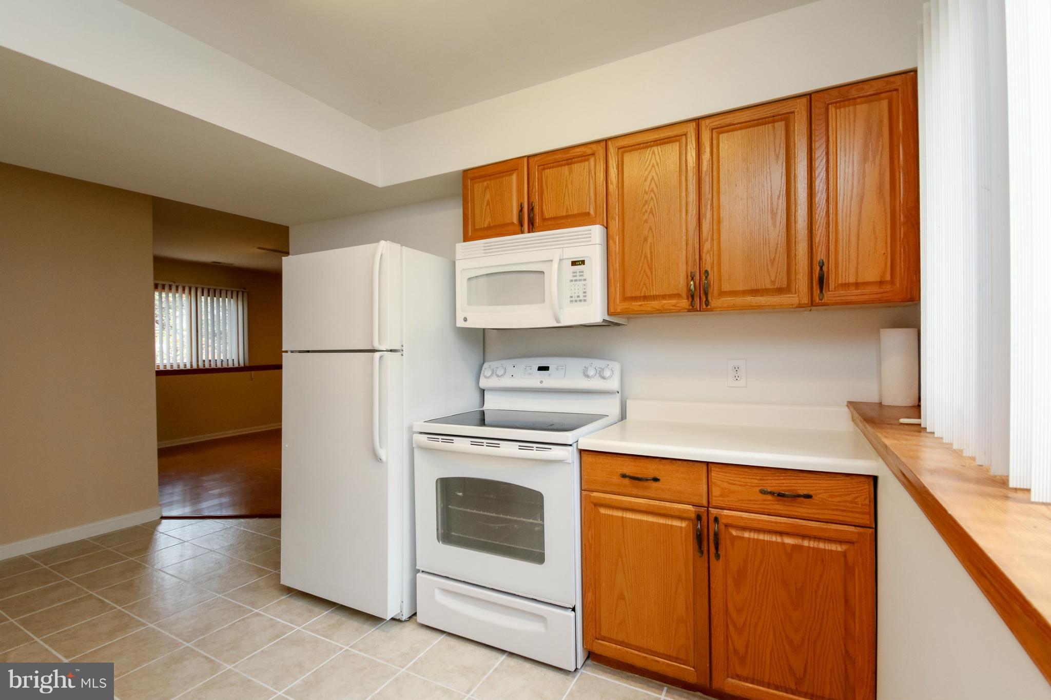 511 East Quaker Bottom Road Sparks, MD 21152 - Photo 7 of 30 a kitchen with a stove top oven sink and refrigerator