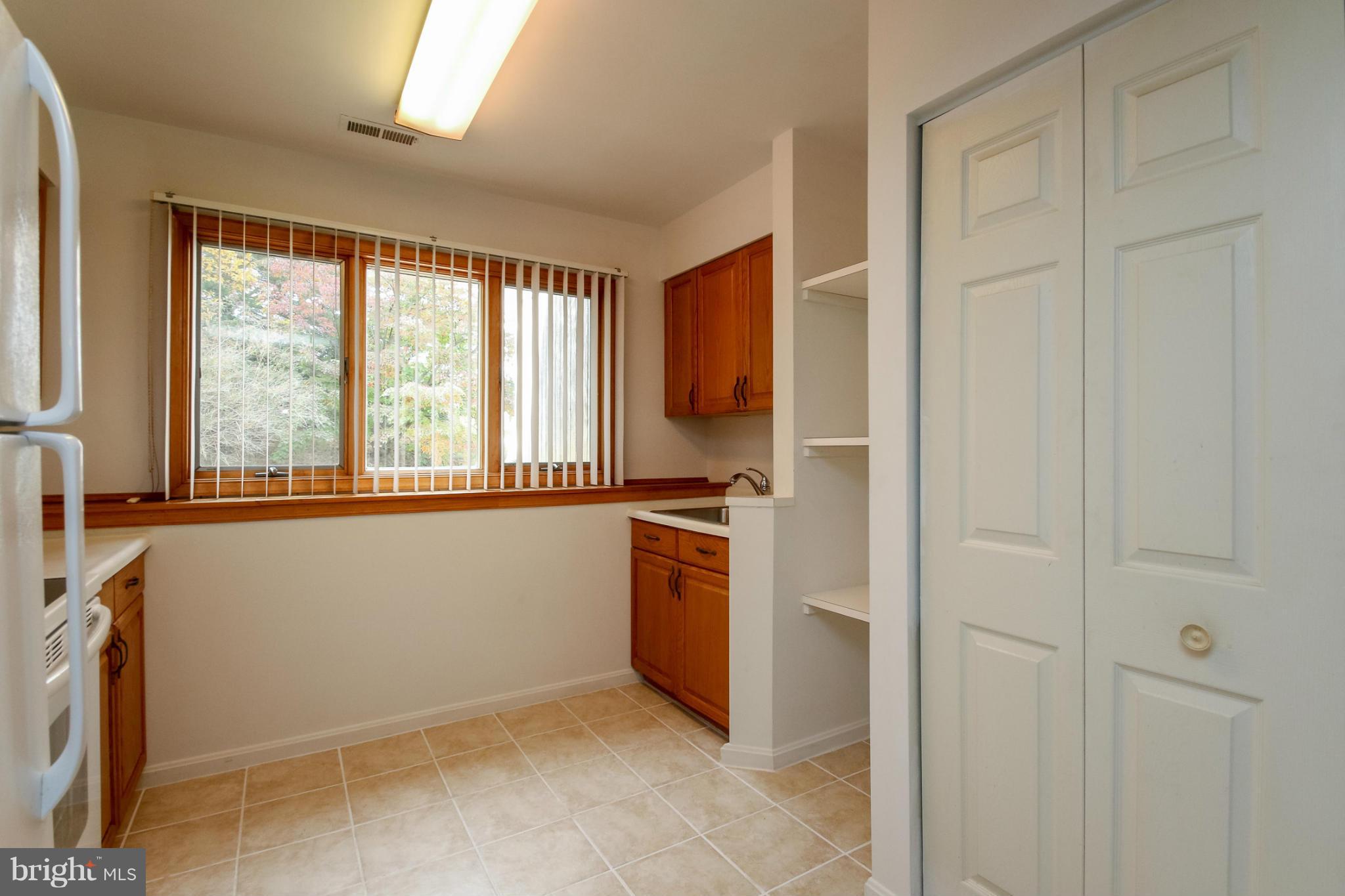 511 East Quaker Bottom Road Sparks, MD 21152 - Photo 8 of 30 a view of an empty room with a kitchen