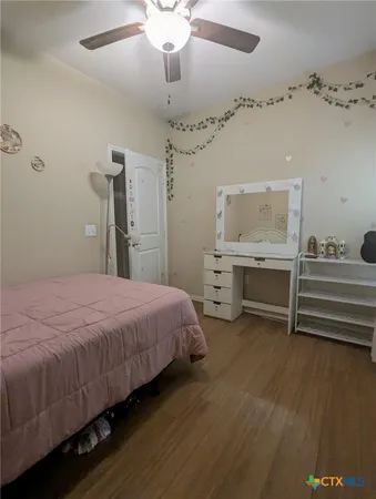 a bedroom with a bed and a desk