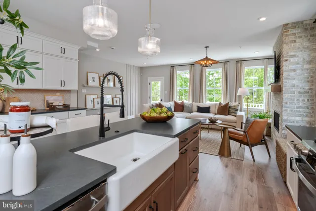 a kitchen with a table chairs stove and wooden floor
