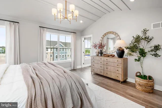 a bedroom with bed and wooden floor