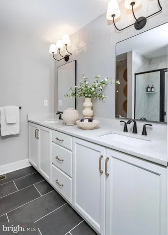 a bathroom with a double vanity sink and mirror