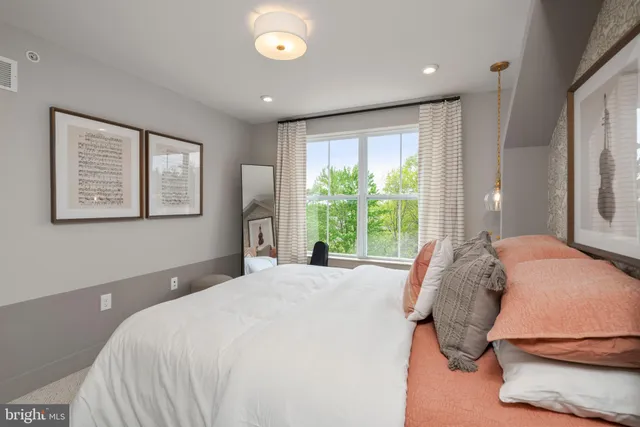 a bedroom with a large bed and a window