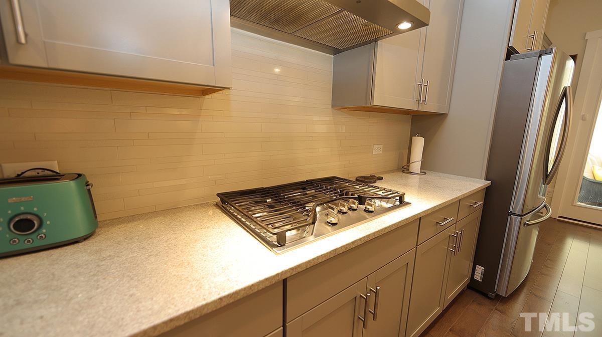 5526 Beardall Street Raleigh, NC 27616 - Photo 14 of 34 Beautiful tile backsplash and gas range.
