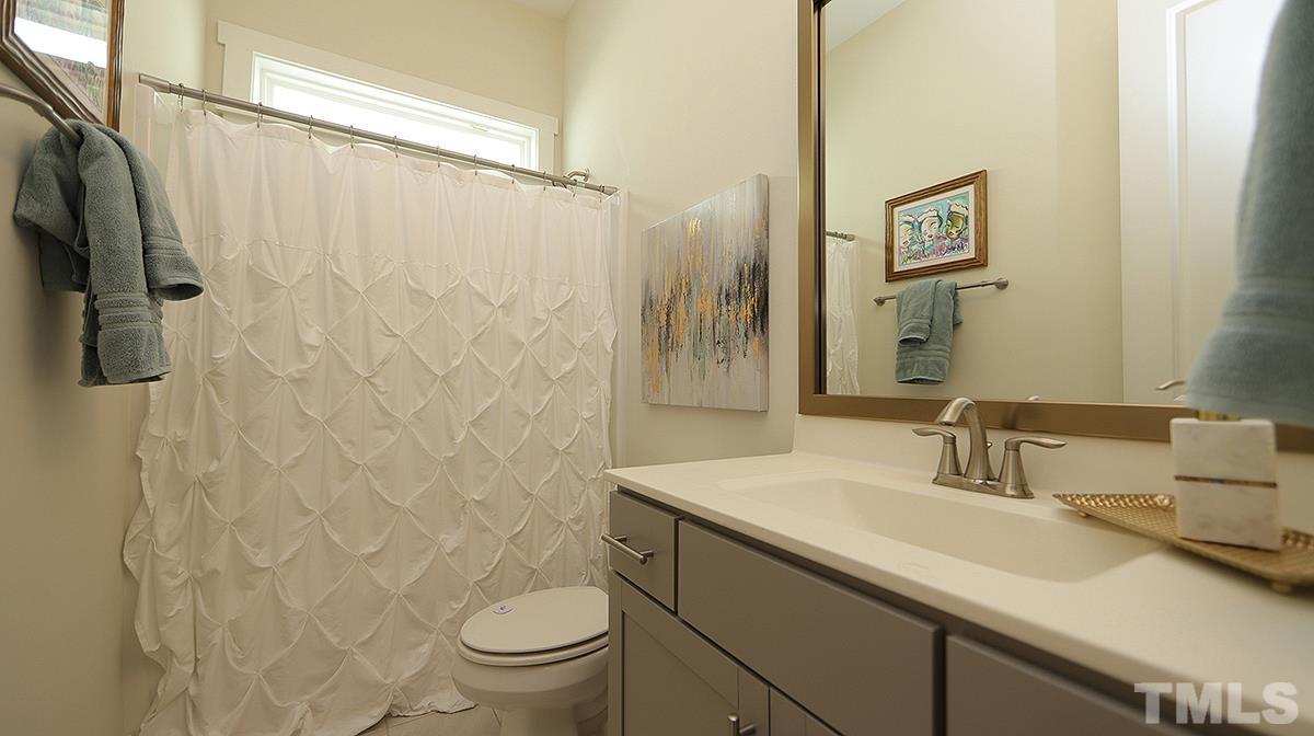 5526 Beardall Street Raleigh, NC 27616 - Photo 23 of 34 1st Floor full Bath between current office and Laundry Room. Nice added transom window brings in more natural light.