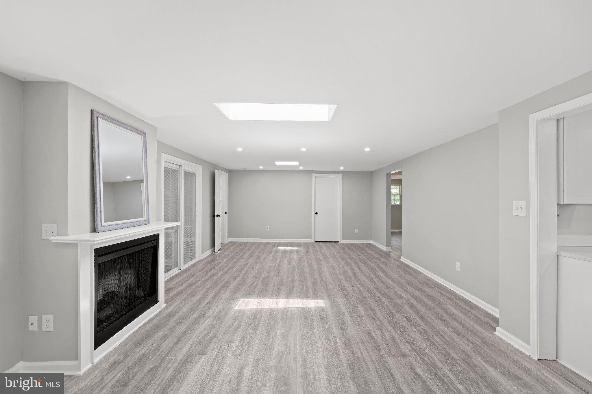 8405 Shirley Road Spotsylvania, VA 22551 - Photo 13 of 42 a view of empty room with wooden floor and fireplace