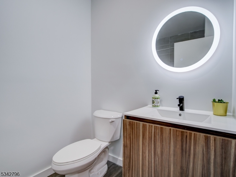 486 Market Street Newark, NJ 07105 - Photo 17 of 34 a bathroom with a sink a toilet and a mirror