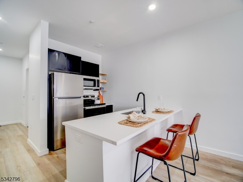 486 Market Street Newark, NJ 07105 - Photo 20 of 34 a kitchen with a dining table and chairs