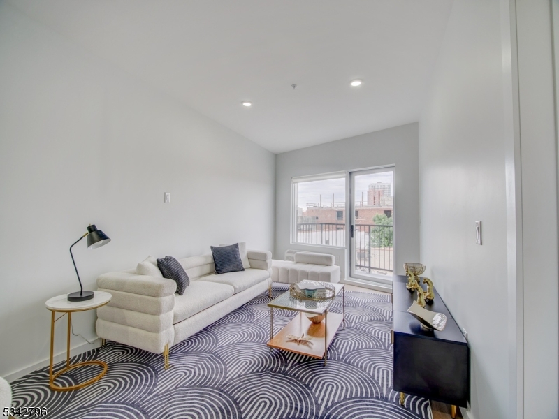 486 Market Street Newark, NJ 07105 - Photo 22 of 34 a living room with furniture a rug and a floor to ceiling window