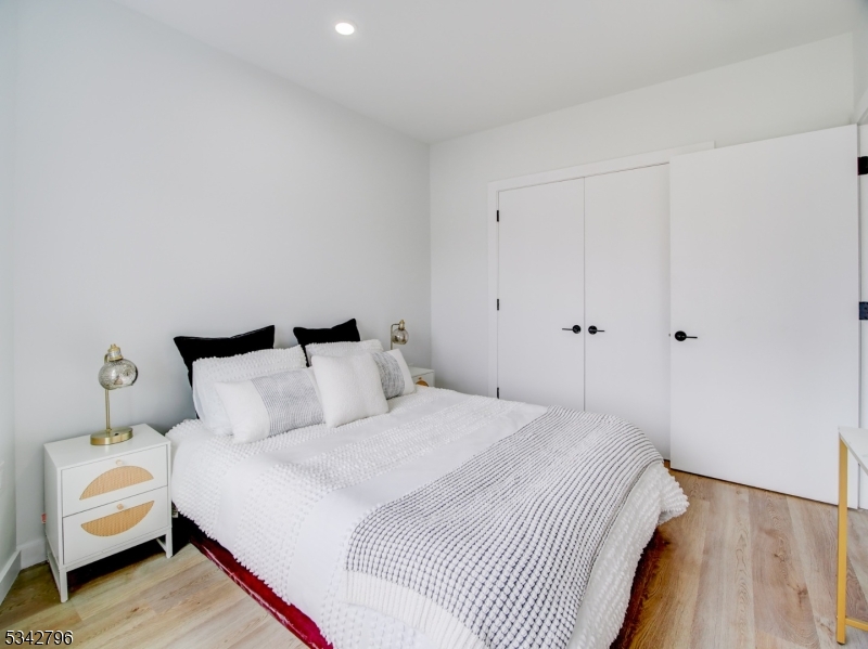 486 Market Street Newark, NJ 07105 - Photo 28 of 34 a bedroom with a bed and wooden floor