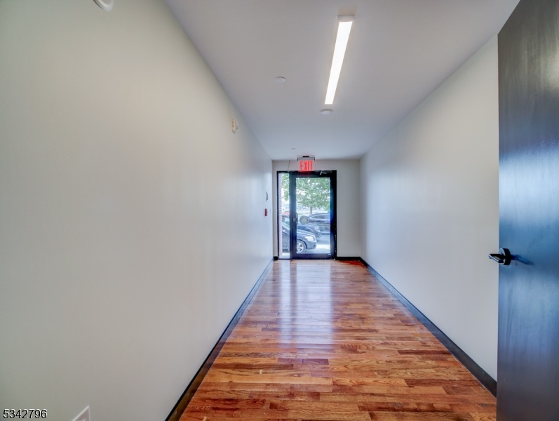 486 Market Street Newark, NJ 07105 - Photo 34 of 34 an empty room with wooden floor and windows