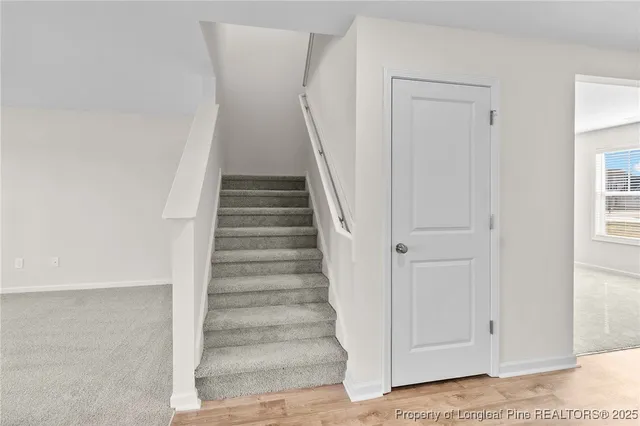 a view of entryway with white walls and stairs