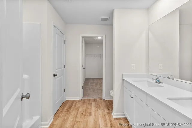 a bathroom with a sink a mirror and a shower