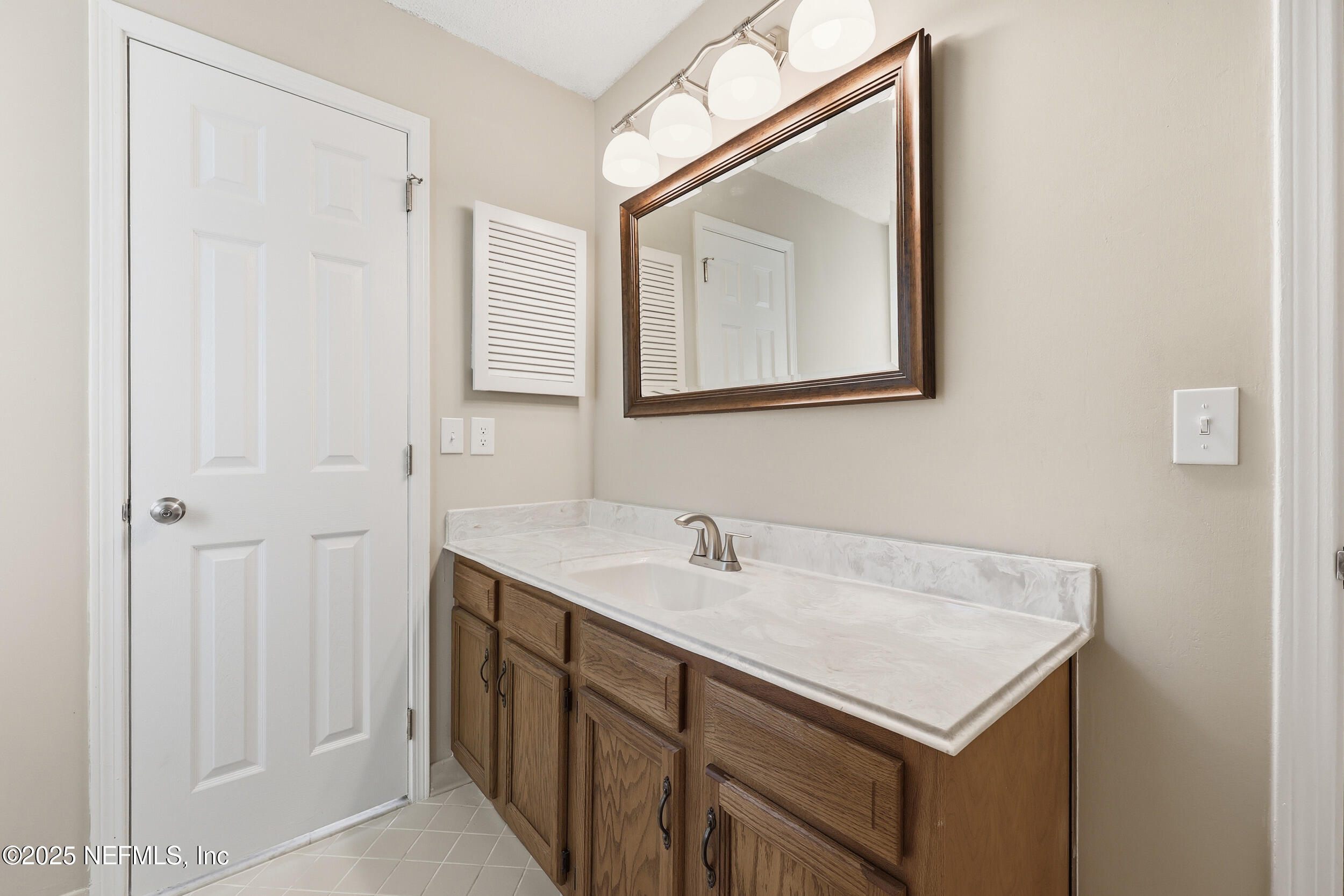 3225 Trophy Place Jacksonville, FL 32225 - Photo 20 of 30 a bathroom with a sink and a mirror