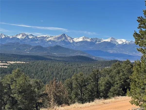 a view of a mountain with a snow in the background