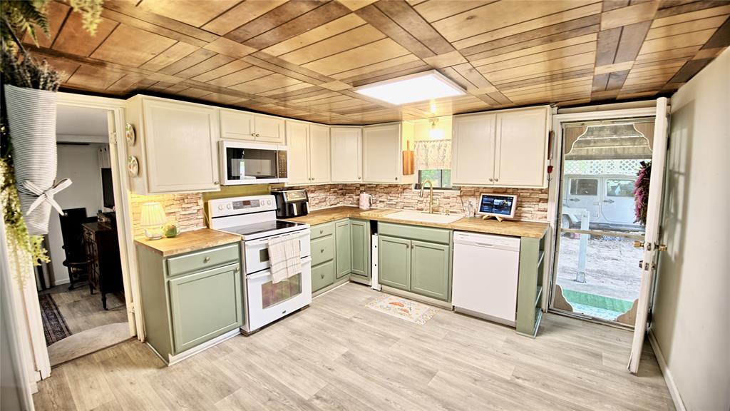 140 Elm Road Nocona, TX 76255 - Photo 9 of 26 a kitchen with stainless steel appliances granite countertop a stove a sink and a refrigerator