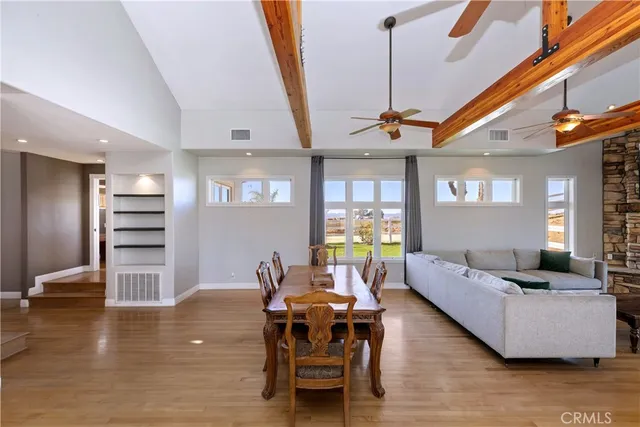 a room with wooden floor and windows