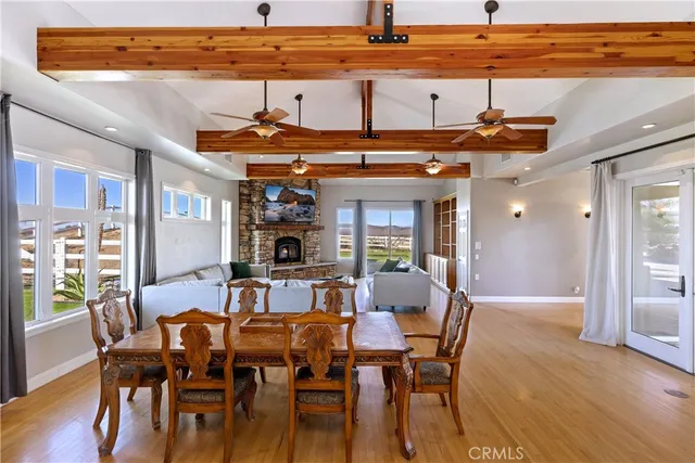 a view of a hallway with wooden floor and windows