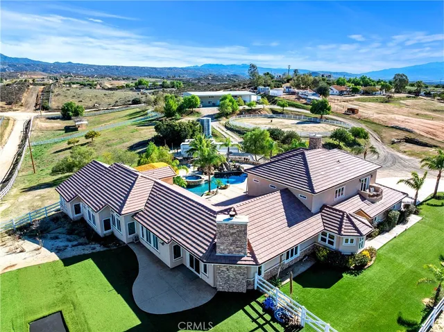 a aerial view of a house with a big yard and large trees