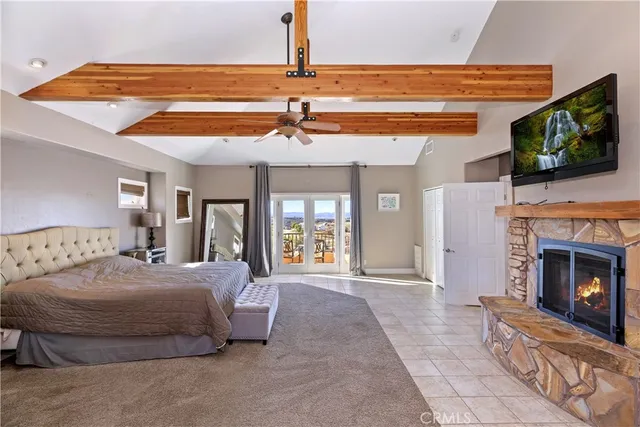 a view of empty room with wooden floor and ceiling fan